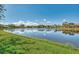 Picturesque lake view showcasing calm waters, lush greenery, and reflections of the community homes at 2660 Sable Palm Way, Port Charlotte, FL 33953