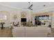 Inviting living room featuring a decorative archway, large television, and access to the lanai at 2660 Sable Palm Way, Port Charlotte, FL 33953