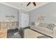 Comfortable living room with black wooden floors and light grey walls, perfect for relaxing and entertaining at 2660 Sable Palm Way, Port Charlotte, FL 33953