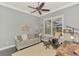 Cozy living room features a ceiling fan, stylish furniture, and natural light from the window at 2660 Sable Palm Way, Port Charlotte, FL 33953