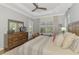 Bright main bedroom with a tray ceiling, large dresser, and windows with plantation shutters at 2660 Sable Palm Way, Port Charlotte, FL 33953