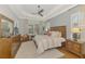 Spacious main bedroom featuring a tray ceiling, large windows, and stylish wooden furniture at 2660 Sable Palm Way, Port Charlotte, FL 33953