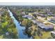 Aerial view of a neighborhood with a canal running through it at 3204 Depew Ave, Port Charlotte, FL 33952