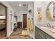 Bright bathroom featuring wood-look tile, neutral walls, vanity with granite countertop, and an oval mirror at 3204 Depew Ave, Port Charlotte, FL 33952