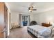 Bedroom showcasing a ceiling fan, a glass sliding door to the lanai and a neutral color scheme at 3204 Depew Ave, Port Charlotte, FL 33952