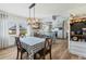 Cozy dining area with views to the kitchen, custom cabinetry, and modern light fixture at 3204 Depew Ave, Port Charlotte, FL 33952