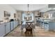 Bright dining room boasts custom cabinets, a farmhouse table, and an elegant chandelier at 3204 Depew Ave, Port Charlotte, FL 33952