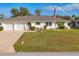 Inviting single-story home with a neat lawn and a charming American flag display at 3204 Depew Ave, Port Charlotte, FL 33952