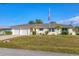 Well-maintained single-story home with a neatly kept lawn and a two-car garage at 3204 Depew Ave, Port Charlotte, FL 33952