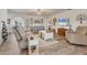 Cozy living room featuring wood-look tile flooring and comfortable seating arrangement at 3204 Depew Ave, Port Charlotte, FL 33952