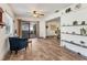 Bright living room with wood-look tile flooring and sliding glass doors leading outside at 3204 Depew Ave, Port Charlotte, FL 33952