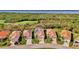 Charming aerial view of a home with solar panels on a red tile roof near a lush golf course at 3307 Osprey Ln, Port Charlotte, FL 33953