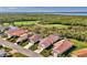 Scenic aerial view of residences with screened lanais and a golf course, providing a picturesque setting at 3307 Osprey Ln, Port Charlotte, FL 33953