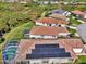 Aerial view featuring a tile-roofed home equipped with solar panels for sustainable energy at 3307 Osprey Ln, Port Charlotte, FL 33953