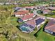 Real estate aerial photo of homes in a tropical neighborhood with lush landscaping and solar panels on home at 3307 Osprey Ln, Port Charlotte, FL 33953