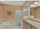 Luxurious bathroom with glass shower, soaking tub, granite vanity and large mirror at 3307 Osprey Ln, Port Charlotte, FL 33953