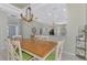 Open dining area featuring tile floors, a tray ceiling, and modern chandelier at 3307 Osprey Ln, Port Charlotte, FL 33953