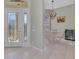 Elegant foyer with tiled floors, ornate glass front door, and dining room access at 3307 Osprey Ln, Port Charlotte, FL 33953