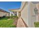 Inviting front entrance featuring a brick walkway and beautiful landscaping at 3307 Osprey Ln, Port Charlotte, FL 33953