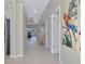 Bright hallway featuring neutral paint and tile flooring leading to the living areas at 3307 Osprey Ln, Port Charlotte, FL 33953