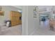 Open hallway with views of the kitchen, dining area, and lanai at 3307 Osprey Ln, Port Charlotte, FL 33953