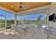 Outdoor dining patio with screened enclosure, a ceiling fan, and a view of the pool at 3307 Osprey Ln, Port Charlotte, FL 33953