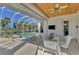 Outdoor dining patio with screened enclosure, a ceiling fan, and a view of the pool at 3307 Osprey Ln, Port Charlotte, FL 33953