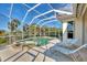 Screened in pool and hot tub surrounded by tropical landscaping at 3307 Osprey Ln, Port Charlotte, FL 33953