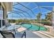 Inviting screened-in pool and spa area with clear blue water, surrounded by comfortable patio furniture at 3307 Osprey Ln, Port Charlotte, FL 33953