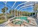 Screened in pool and hot tub surrounded by tropical landscaping at 3307 Osprey Ln, Port Charlotte, FL 33953