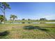 Landscaped backyard with view of golf course and lake at 404 Cerromar N Cir # 112, Venice, FL 34293