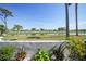 Scenic backyard view overlooking a peaceful lake and golf course at 404 Cerromar N Cir # 112, Venice, FL 34293