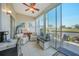 Bright sunroom with seating and golf course view at 404 Cerromar N Cir # 112, Venice, FL 34293