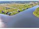 Beautiful aerial view of new construction lakeside homes with lush landscaping, and spacious waterfront lots at 43 Blue Hen Dr, Placida, FL 33946