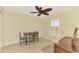 Bedroom features a ceiling fan, neutral walls, and a window overlooking the backyard at 43 Blue Hen Dr, Placida, FL 33946