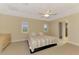 Bedroom featuring large windows with blinds, ceiling fan, and neutral color palette at 43 Blue Hen Dr, Placida, FL 33946