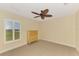 Bedroom featuring a ceiling fan, neutral walls, and a window overlooking the backyard at 43 Blue Hen Dr, Placida, FL 33946