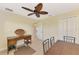 Bedroom with a ceiling fan, desk, and closet doors at 43 Blue Hen Dr, Placida, FL 33946