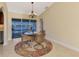 Cozy dining area featuring a chandelier, seating, and access to the pool at 43 Blue Hen Dr, Placida, FL 33946