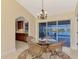 Dining area featuring a chandelier, seating, and views of the pool at 43 Blue Hen Dr, Placida, FL 33946