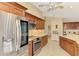 View of kitchen with wood cabinetry, stainless appliances, and tiled floors at 43 Blue Hen Dr, Placida, FL 33946