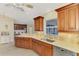 Kitchen area featuring wood cabinetry, light countertops, stainless steel appliances, and a window view at 43 Blue Hen Dr, Placida, FL 33946