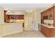 Kitchen area showcasing wood cabinetry, tile backsplash, and a wine cooler with ample counter space at 43 Blue Hen Dr, Placida, FL 33946