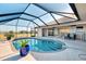 Stunning screened-in pool with lake views, outdoor dining, and lush landscaping; ideal for entertaining at 43 Blue Hen Dr, Placida, FL 33946