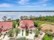 Gorgeous waterfront living featuring verdant trees and pristine landscaping near the home's peaceful boardwalk at 4754 Club Dr # 201, Port Charlotte, FL 33953