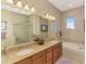 Bathroom featuring double vanity, granite countertops, soaking tub and tiled shower at 4754 Club Dr # 201, Port Charlotte, FL 33953