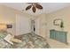 Bedroom features ceiling fan, walk-in closet, and colorful accent dresser at 4754 Club Dr # 201, Port Charlotte, FL 33953