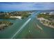 Aerial view of waterfront homes and boat traffic at 5 Pointe Way, Placida, FL 33946