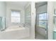 Bathroom with soaking tub, walk-in shower, and window with etched glass at 5 Pointe Way, Placida, FL 33946