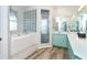 Bathroom with double vanity, soaking tub, and glass-block wall at 5 Pointe Way, Placida, FL 33946